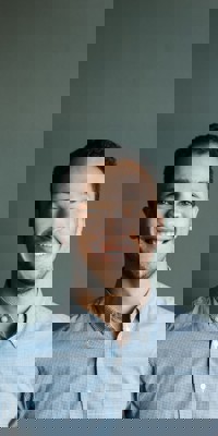 Man in blue shirt with hands in pocket